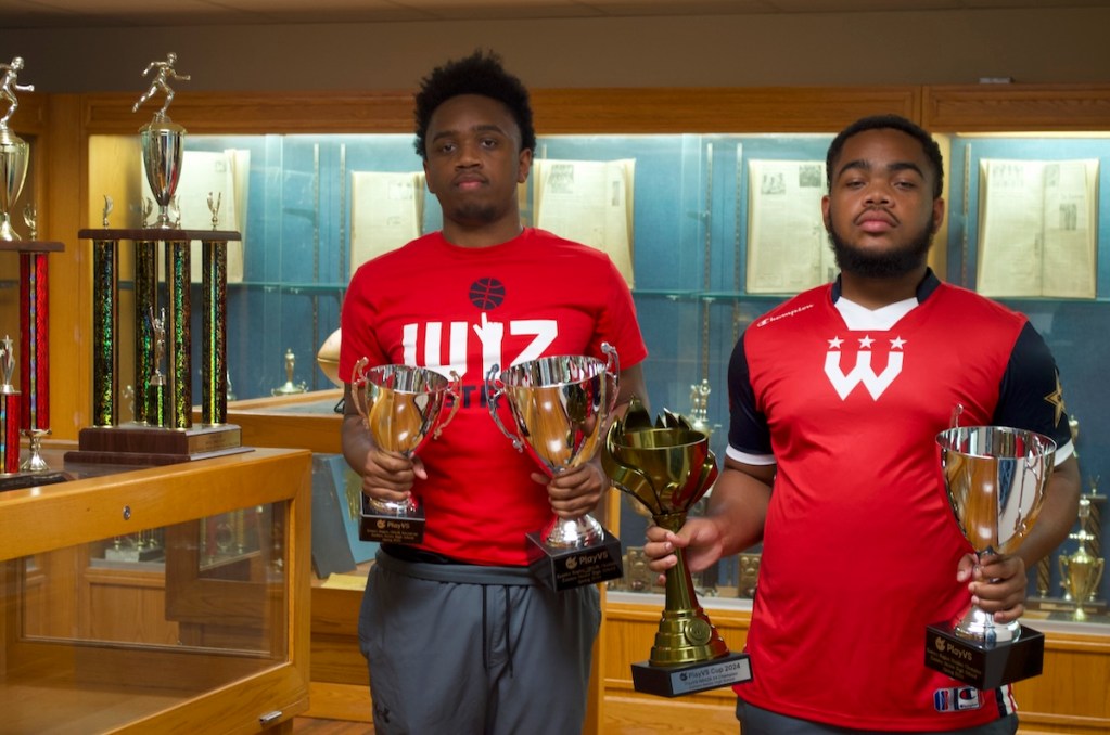 Taylor Frost (left) and Tyler Frost (right) stand with their championship hardware. (Demarco Rush/The Washington Informer)