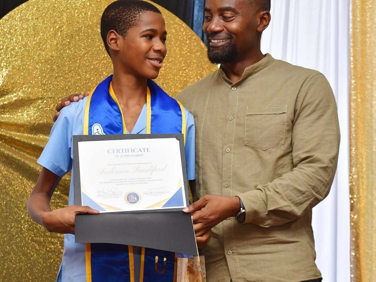 Anderson Sandiford collecting his prizes from Minister of People Empowerment Kirk Humphrey (Courtesy photo)