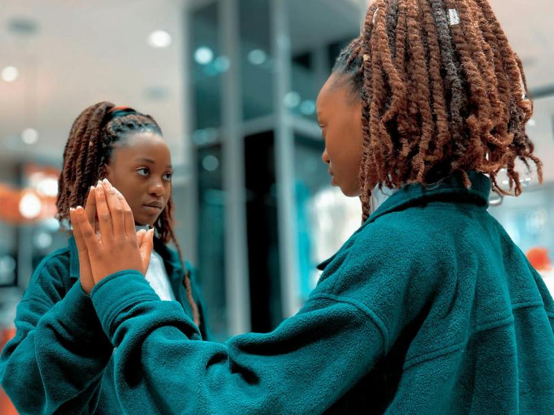 woman touching a mirror